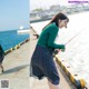 A woman is fishing on the pier by the water.