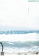 A bicycle is parked on the beach by the ocean.