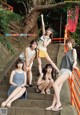 A group of young women sitting on the steps of a building.